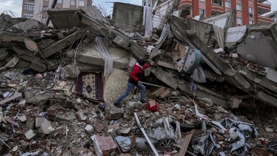 A man walks among rubble as he searches for people in a destroyed building in Turkey. (AP) A man walks among rubble as he searches for people in a destroyed building in Turkey. (AP)