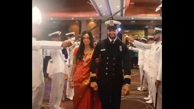 Lt Neil and Parvathy are being welcomed by Navy officers with an arch of sabers. (Twitter/@hvgoenka) Lt Neil and Parvathy are being welcomed by Navy officers with an arch of sabers. (Twitter/@hvgoenka)
