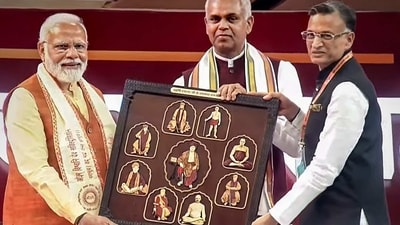 PM Modi being presented a photo collage of Maharishi Dayanand Saraswati by Gujarat Governor Acharya Devvrat on Sunday. (PTI) PM Modi being presented a photo collage of Maharishi Dayanand Saraswati by Gujarat Governor Acharya Devvrat on Sunday. (PTI)