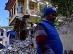 A man walks by the rubble of collapsed buildings in the southern city of Antakya in Turkey, A man walks by the rubble of collapsed buildings in the southern city of Antakya in Turkey,