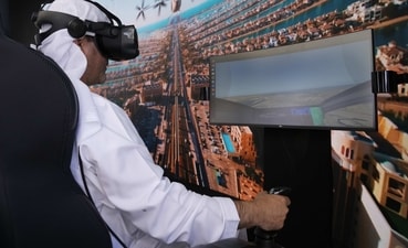 A man experiences a driving simulator of a flying taxi during the World Government Summit in Dubai on Monday, (AP) A man experiences a driving simulator of a flying taxi during the World Government Summit in Dubai on Monday, (AP)