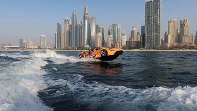 A person drives a jet car, a car shaped speed boat, in Dubai. (REUTERS)