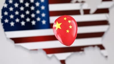 Chinese Spy Balloon: A printed balloon with Chinese flag is placed on a US flag in the shape of US map outline, in this illustration. (Reuters)