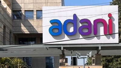 Employees walk past the Adani House corporate building at the institutional area in Gurugram on February 8, 2023. (AFP) Employees walk past the Adani House corporate building at the institutional area in Gurugram on February 8, 2023. (AFP)