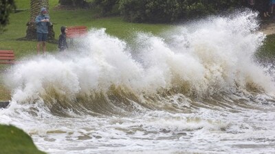 New Zealand Cyclone Gabrielle: People watch as waves crash against a sea wall at an Auckland beach as a cyclone hits the upper parts of New Zealand. (AP) New Zealand Cyclone Gabrielle: People watch as waves crash against a sea wall at an Auckland beach as a cyclone hits the upper parts of New Zealand. (AP)