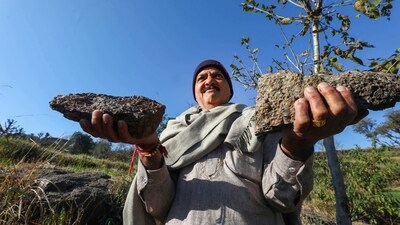 Reasi: A villager shows lithium stones in Reasi district, Sunday, Feb. 12, 2023. The Geological Survey of India (GSI) has for the first time established 5.9 million tonnes of inferred resources of lithium in the Salal-Haimana area of Jammu & Kashmir. (PTI Photo)(PTI02_12_2023_000120A) (PTI) Reasi: A villager shows lithium stones in Reasi district, Sunday, Feb. 12, 2023. The Geological Survey of India (GSI) has for the first time established 5.9 million tonnes of inferred resources of lithium in the Salal-Haimana area of Jammu & Kashmir. (PTI Photo)(PTI02_12_2023_000120A) (PTI)