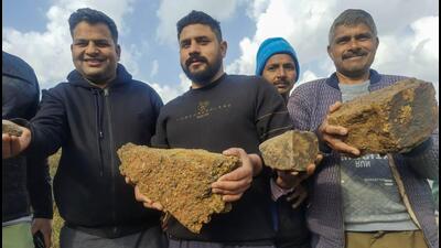 Residents of Salal village pose for photos showing lithium stones in Reasi district on Saturday. The Geological Survey of India (GSI) has for the first time established 5.9 million tonnes of inferred resources of lithium in the Salal-Haimana area of Jammu & Kashmir. (PTI) Residents of Salal village pose for photos showing lithium stones in Reasi district on Saturday. The Geological Survey of India (GSI) has for the first time established 5.9 million tonnes of inferred resources of lithium in the Salal-Haimana area of Jammu & Kashmir. (PTI)