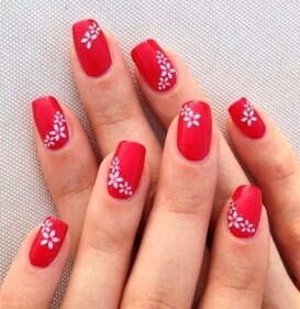 White flowers can be used to add charm and refinement to red nails. (pinterest) White flowers can be used to add charm and refinement to red nails. (pinterest)