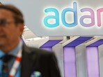 Bengaluru: An official walks past the stall of Adani Defence and Aerospace during the inauguration of Aero India 2023, at Yelahanka air base in Bengaluru, Monday, Bengaluru: An official walks past the stall of Adani Defence and Aerospace during the inauguration of Aero India 2023, at Yelahanka air base in Bengaluru, Monday,