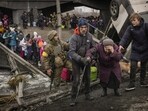 An elderly woman is assisted while crossing the Irpin River on an improvised path under a bridge that was destroyed by Ukrainian troops designed to slow any Russian military advance, while fleeing the town of Irpin, Ukraine, March 5, 2022. (AP Photo/Vadim Ghirda) An elderly woman is assisted while crossing the Irpin River on an improvised path under a bridge that was destroyed by Ukrainian troops designed to slow any Russian military advance, while fleeing the town of Irpin, Ukraine, March 5, 2022. (AP Photo/Vadim Ghirda)