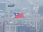 China-Taiwan Conflict: A Chinook helicopter carrying a Taiwan flag flies over the city during the country's National Day celebration in Taipei, Taiwan.