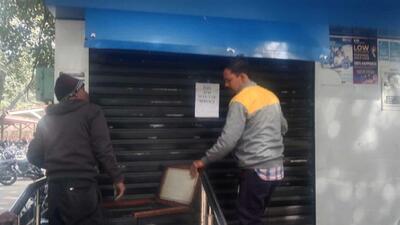 A team attempting to cut open the ATM kiosk’s shutter to rescue the cleaning worked trapped inside at the mini-secretariat in Ludhiana. (HT Photo)