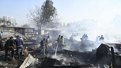 Gurugram, India-February 14, 2023: Fire fighters trying to douse off fire gutted inside a slum area at Ghasola village sector-49 near Uppal Southend society in Gurugram, India, on Tuesday, 14 February 2023. More than 100 Jhuggis gutted in fire due to an unknown reason (Photo by Parveen Kumar/Hindustan Times)