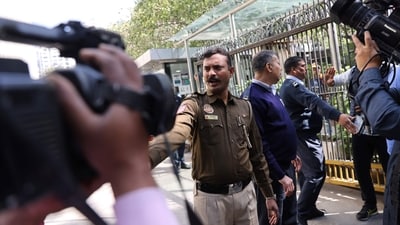 Police officers stand outside a building having BBC offices, where income tax officials conducted a search, in New Delhi. (REUTERS)