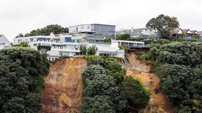 Cyclone Gabrielle top updates: A view of a slip near a house on a clifftop caused by continuous bad weather as Cyclone Gabrielle approaches in Auckland, New Zealand. (Reuters)