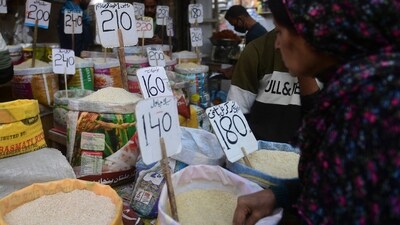 Pakistan Economic Crisis: A woman checks rice prices at a main wholesale market in Karachi. (AFP) Pakistan Economic Crisis: A woman checks rice prices at a main wholesale market in Karachi. (AFP)