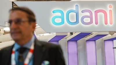 Bengaluru: An official walks past the stall of Adani Defence and Aerospace during the inauguration of Aero India 2023, at Yelahanka air base in Bengaluru, Monday, (PTI) Bengaluru: An official walks past the stall of Adani Defence and Aerospace during the inauguration of Aero India 2023, at Yelahanka air base in Bengaluru, Monday, (PTI)