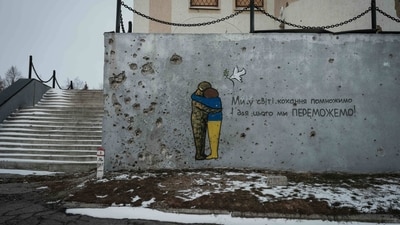 Graffiti adorns a wall bearing shrapnel impacts, in Kupiansk on February 13, 2023, amid the Russian invasion of Ukraine. (Photo by YASUYOSHI CHIBA / AFP) (AFP) Graffiti adorns a wall bearing shrapnel impacts, in Kupiansk on February 13, 2023, amid the Russian invasion of Ukraine. (Photo by YASUYOSHI CHIBA / AFP) (AFP)