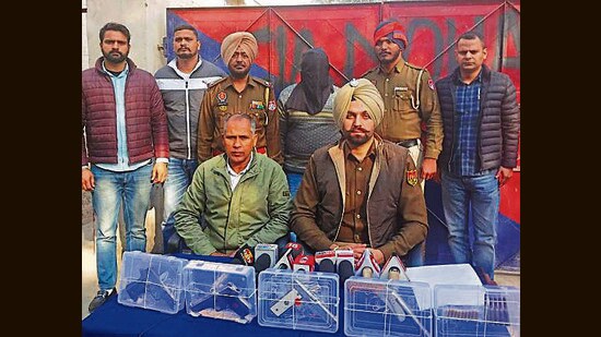 The accused with recovered arms in police custody. (HT Photo)