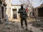 A Taliban fighter checks an Islamic State group house destroyed in the ongoing conflict between the two in Kabul, Afghanistan. A Taliban fighter checks an Islamic State group house destroyed in the ongoing conflict between the two in Kabul, Afghanistan.