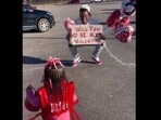 The picture shows the father asking his daughter to be his valentine through a placard. The picture shows the father asking his daughter to be his valentine through a placard.
