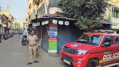 A policeman stands guard during NIA searches in Coimbatore on Wednesday. (PTI) A policeman stands guard during NIA searches in Coimbatore on Wednesday. (PTI)