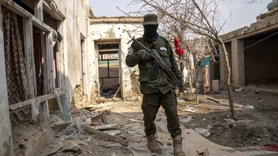 A Taliban fighter checks an Islamic State group house destroyed in the ongoing conflict between the two in Kabul, Afghanistan. (AP) A Taliban fighter checks an Islamic State group house destroyed in the ongoing conflict between the two in Kabul, Afghanistan. (AP)