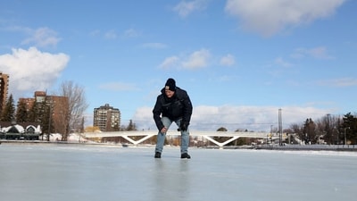Bruce Devine, senior manager facilities and programs at the National Capital Commission checks the ice condition on the Rideau Canal on February 8, 2023 in Ottawa, Canada. - This winter has brought wild and unseasonably warm weather to Canada's capital, raising the prospect that its Rideau Canal skateway -- the longest in the world -- will not open this season for the first time, due to a lack of ice. "Mother Nature has presented us with a big challenge this year," Devine told AFP. (Photo by Dave Chan / AFP) (AFP) Bruce Devine, senior manager facilities and programs at the National Capital Commission checks the ice condition on the Rideau Canal on February 8, 2023 in Ottawa, Canada. - This winter has brought wild and unseasonably warm weather to Canada's capital, raising the prospect that its Rideau Canal skateway -- the longest in the world -- will not open this season for the first time, due to a lack of ice. "Mother Nature has presented us with a big challenge this year," Devine told AFP. (Photo by Dave Chan / AFP) (AFP)