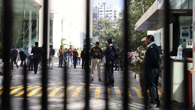 Police officers stand outside a building having BBC offices, where income tax officials are conducting a search, in New Delhi. (Reuters)