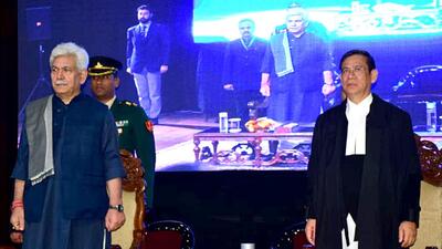 Lieutenant governor Manoj Sinha with the newly sworn-in chief justice of J&K and Ladakh high court Justice Nongmeikapam Kotiswar Singh, in Jammu on Wednesday. (ANI)