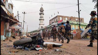 Security personnel patrol after a clash between two groups at Panki, in Palamu district on Wednesday. (PTI)