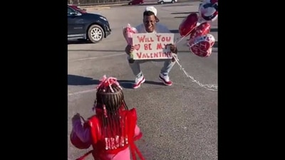 The picture shows the father asking his daughter to be his valentine through a placard. (Twitter/@CharriseJLane)