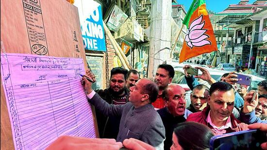 Former HP chief minister Jai Ram Thakur participating in BJP’s signature campaign, in Seraj on Wednesday. (ANI Pic Service)