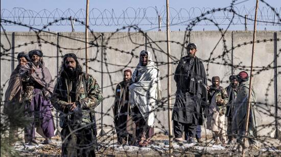 Taliban fighters check the site of an explosion near the Interior Ministry in Kabul, Afghanistan (AP File Photo)