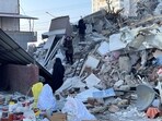 People search for their belongings among rubble, in the aftermath of the deadly earthquake, in Elbistan town, Kahramanmaras, Turkey 