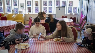A group of young Ukrainian refugee circus students eat together before the start of their training. Svetlana Momot, the trainer told AP that in the past year, the performers had to learn to live, cook, clean and study together in close quarters but her goal from the beginning was to ensure that, despite being uprooted from their homes, their intensive daily training would not be interrupted. (Denes Erdos / AP) A group of young Ukrainian refugee circus students eat together before the start of their training. Svetlana Momot, the trainer told AP that in the past year, the performers had to learn to live, cook, clean and study together in close quarters but her goal from the beginning was to ensure that, despite being uprooted from their homes, their intensive daily training would not be interrupted. (Denes Erdos / AP)