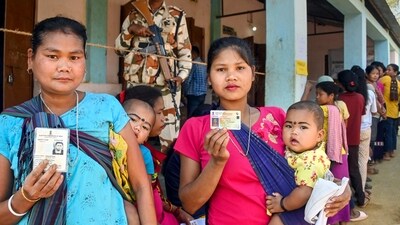 Voters show their identification cards as they wait to cast their votes at a polling booth during the Tripura Assembly elections, at Damchara in North Tripura district. (PTI) Voters show their identification cards as they wait to cast their votes at a polling booth during the Tripura Assembly elections, at Damchara in North Tripura district. (PTI)