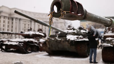 Russia-Ukraine War: Ribbons with the colours of the Ukrainian flag are tied to the cannon of a destroyed Russian tank. (Reuters)