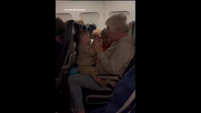 Women help baby calm down during a flight. (Instagram/@Majically) Women help baby calm down during a flight. (Instagram/@Majically)