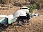 An investigator takes stalk of the wreckage of Yeti Airlines' flight.