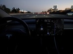 A Tesla Model 3 vehicle is shown driving using Full Self Driving (FSD) beta software.