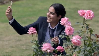 A resident clicks a selfie at the Rose Garden in Chandigarh on Friday. (Ravi Kumar/HT)