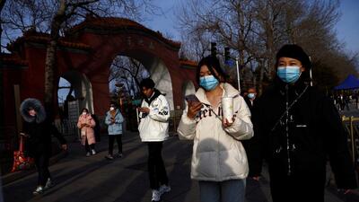 People, wearing masks to prevent coronavirus disease (COVID-19), walk along the street in Beijing. (REUTERS) People, wearing masks to prevent coronavirus disease (COVID-19), walk along the street in Beijing. (REUTERS)