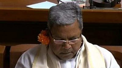 Former Karnataka chief minister and Congress leader Siddaramaiah wears a flower behind his ear to flag what the party says is the BJP state government's inability to meet 2018 poll promises. (Credit: ANI) Former Karnataka chief minister and Congress leader Siddaramaiah wears a flower behind his ear to flag what the party says is the BJP state government's inability to meet 2018 poll promises. (Credit: ANI)