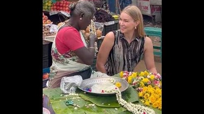 The image shows the UK journalist interacting with a woman in Tamil Nadu. (Twitter/@AlexOuthwaite)