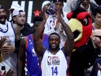 Football player DK Metcalf #14 of Team Dwayne hoist the MVP trophy after the 2023 NBA All Star Ruffles Celebrity Game at Vivint Arena on February 17, 2023 in Salt Lake City, Utah. 