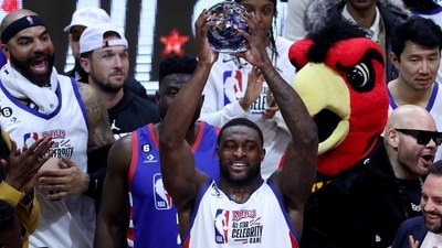 Football player DK Metcalf #14 of Team Dwayne hoist the MVP trophy after the 2023 NBA All Star Ruffles Celebrity Game at Vivint Arena on February 17, 2023 in Salt Lake City, Utah. (Getty Images via AFP)