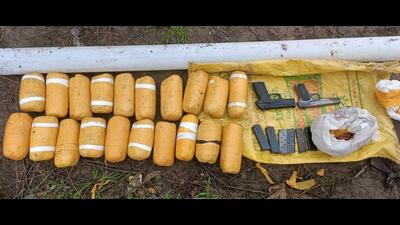 The Border Security Force (BSF) recovered 20 packets of heroin, two foreign-made pistols and ammunition after firing at smugglers spotted across the barbed wire fence near Khasawali village of Gurdaspur district early on Saturday. (HT Photo)