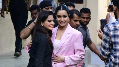 Shraddha Kapoor poses with a fan at Tu Jhoothi Main Makkaar promotions. She also wore a suit jacket in pink with white skirt and sports shoes. 
