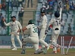 Australia's Pat Cummins is bowled out by India's Ravindra Jadeja.